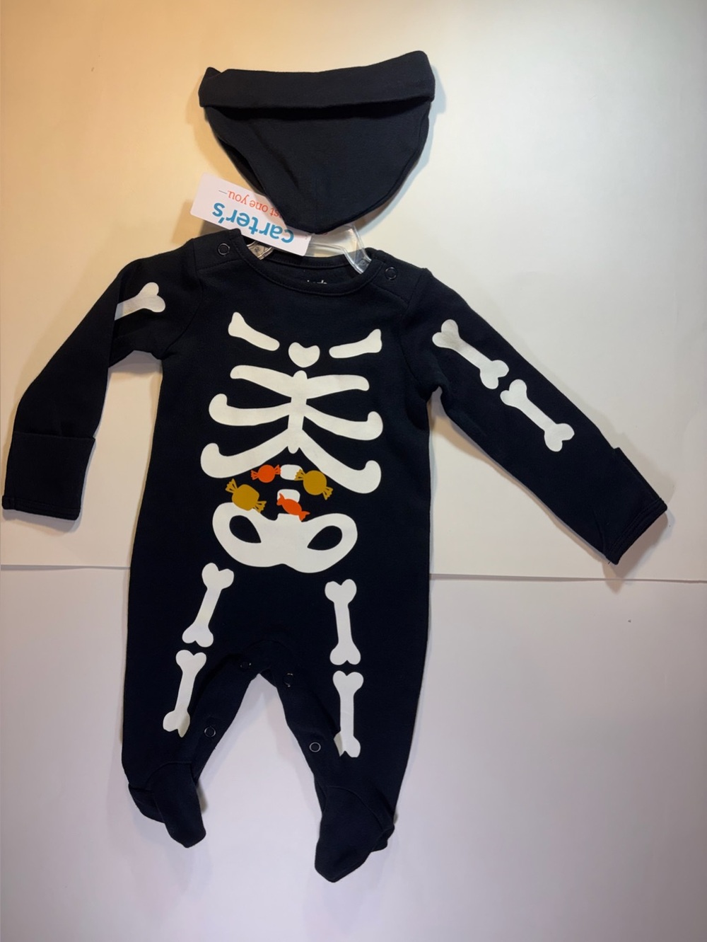 Carter’s Just One Year Footed One-piece Skeleton with candy